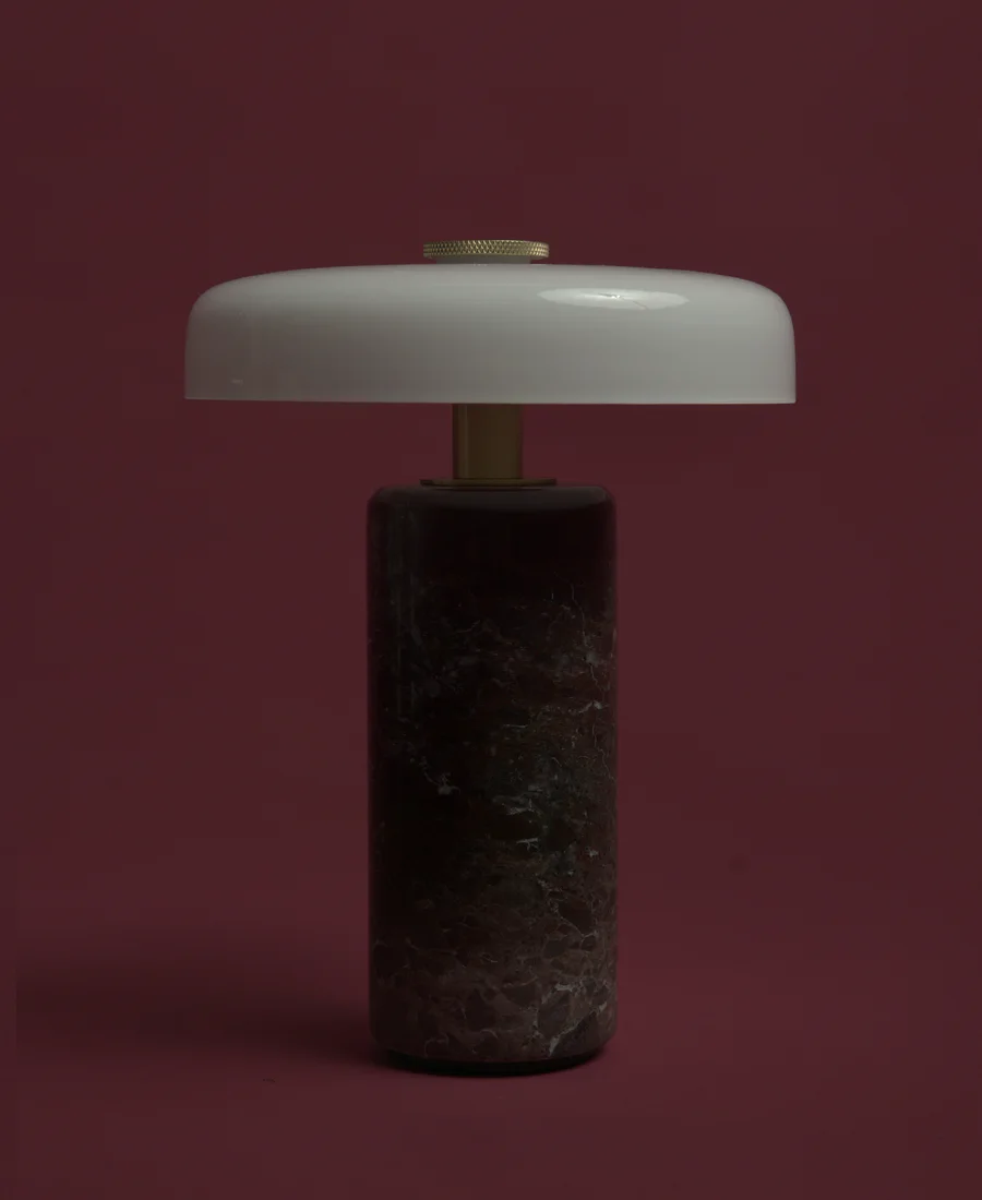 A stone lamp with an opal glass disc. Unlit.