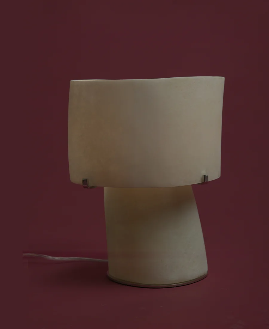 A parchment shade lamp. Unlit.
