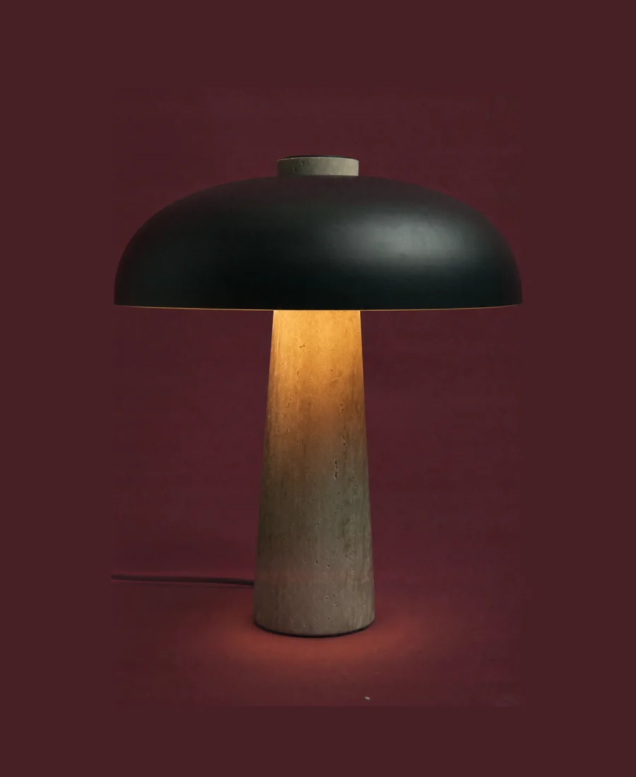 A tall black dome lamp. Lit.
